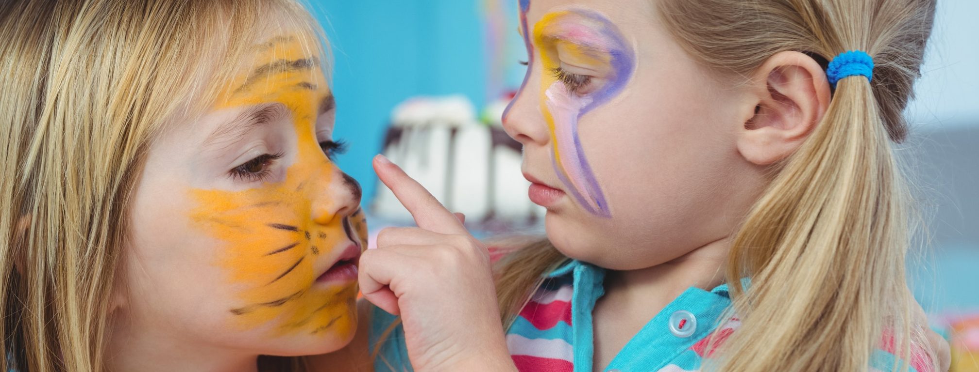 Smiling girls with their faces painted at the birthday party